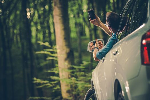 Caucasian Men in His 30s Looking For Cellphone Signal From Inside His Car.