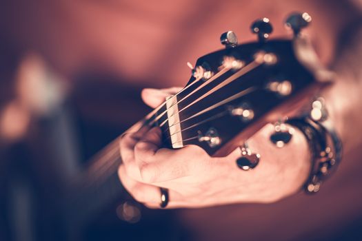 Rock Guitar Player Concept Photo. Hands on the Electric Guitar. Shallow Depth of Field.