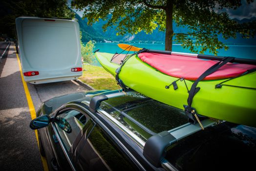 Summer Time Kayak Transportation on the Car Roof Rack. Vacation Trip with the Kayak.
