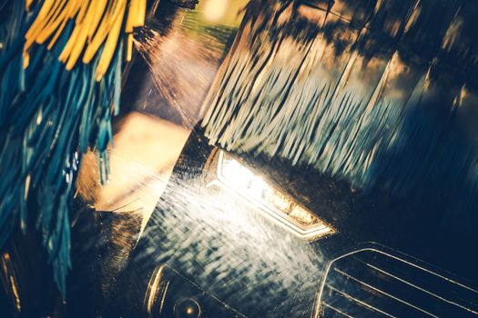 Washing Modern Vehicle. Automatic Brush Car Wash Theme. Closeup Photo.