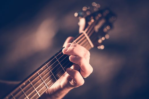 Learning Acoustic Guitar. Hands on the String Instrument Closeup Photo.