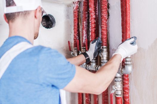 Plumbing Water Supply Check. Caucasian Plumber Worker Testing Installation.