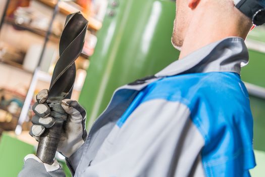 Heavy Duty Drilling Bit in Hand of Metalworking Technician.