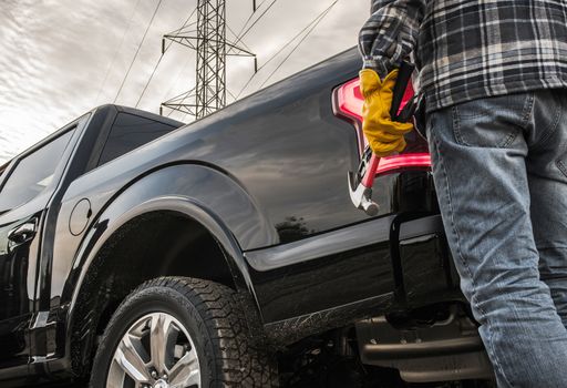 Contractor with Tools and His Truck. Closeup Photo. Construction Theme.