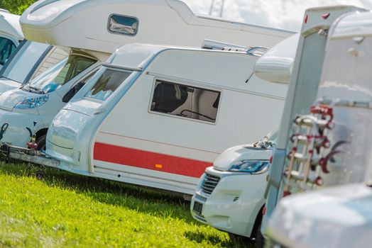 RV Campers Storage Parking with Many Recreational Vehicles in Row.