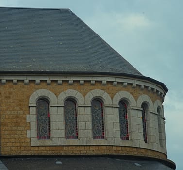 Part of catholic church with rooftop and many windows