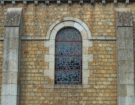 Decorated window on stone bricks wall at cathedral