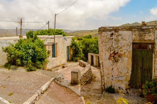 Old abandoned town. Narrow street in old Greek village. Traditional buildings. Destroyed house.  Crete Island, Greece