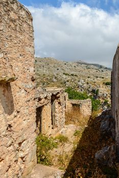 Old abandoned town. Narrow street in old Greek village. Traditional buildings. Destroyed house.  Crete Island, Greece