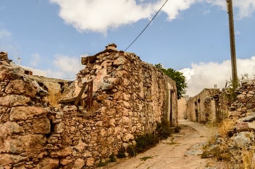 Old abandoned town. Narrow street in old Greek village. Traditional buildings. Destroyed house.  Crete Island, Greece