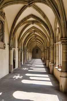 Sunlight through the arches of a corridor in a medieval cloister in trier germany