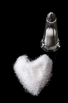 White Sea Salt Crystals Heart with Shaker on Blcak Background