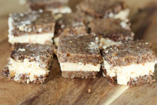 close up of rye bread with aged cheese on wooden background