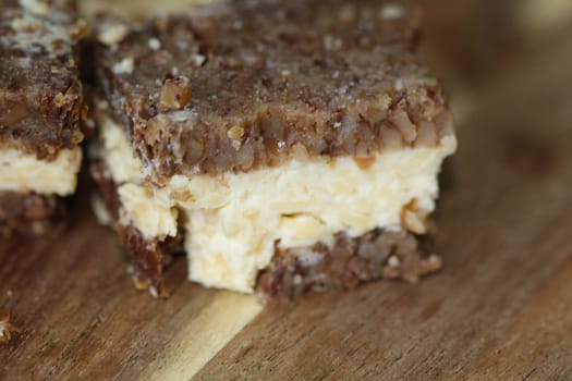 close up of rye bread with aged cheese on wooden background