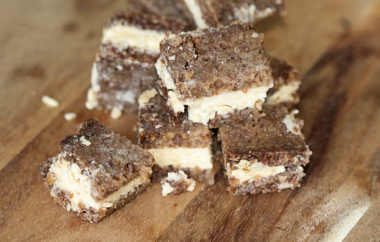 close up of rye bread with aged cheese on wooden background
