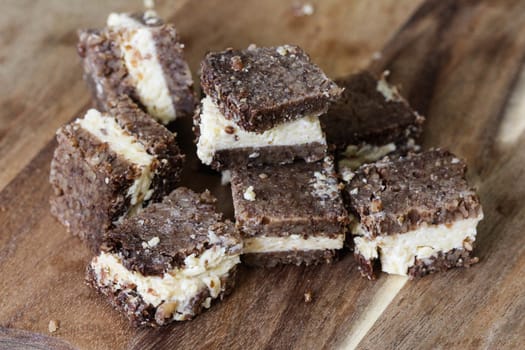 close up of rye bread with aged cheese on wooden background