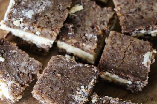 close up of rye bread with aged cheese on wooden background