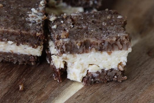 close up of rye bread with aged cheese on wooden background