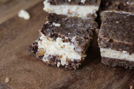 close up of rye bread with aged cheese on wooden background