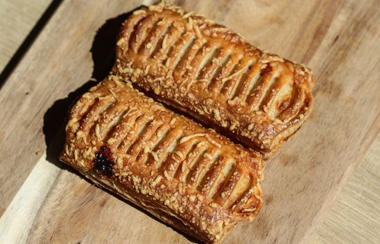 close up of Puff pastry bread filled with cheese, with wooden background