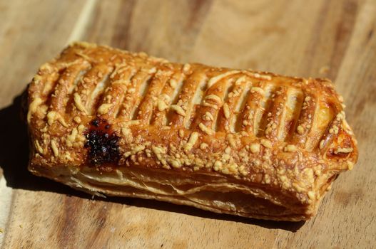 close up of Puff pastry bread filled with cheese, with wooden background