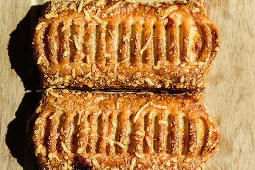 close up of Puff pastry bread filled with cheese, with wooden background