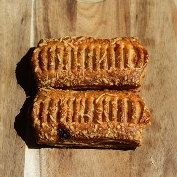 close up of Puff pastry bread filled with cheese, with wooden background