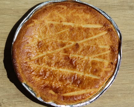 close up of 	
Selfmade Dutch Butter Cake (Boterkoek) cookie, fresh baked from the oven. Displayed on wooden background