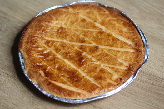 close up of 	
Selfmade Dutch Butter Cake (Boterkoek) cookie, fresh baked from the oven. Displayed on wooden background