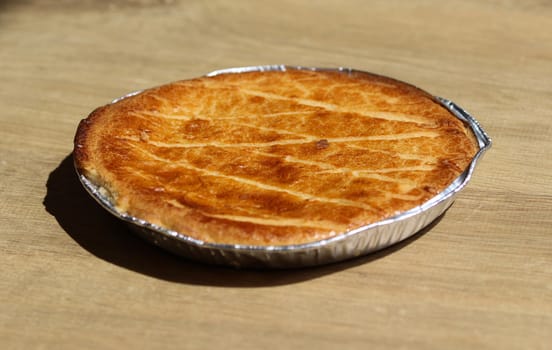 close up of 	
Selfmade Dutch Butter Cake (Boterkoek) cookie, fresh baked from the oven. Displayed on wooden background
