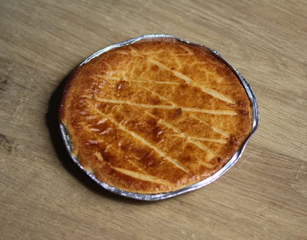 close up of 	
Selfmade Dutch Butter Cake (Boterkoek) cookie, fresh baked from the oven. Displayed on wooden background
