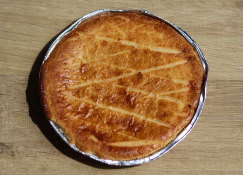 close up of 	
Selfmade Dutch Butter Cake (Boterkoek) cookie, fresh baked from the oven. Displayed on wooden background