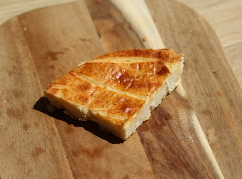 close up of 	
Selfmade Dutch Butter Cake (Boterkoek) cookie, fresh baked from the oven. Displayed on wooden background