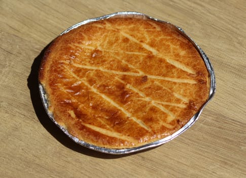 close up of 	
Selfmade Dutch Butter Cake (Boterkoek) cookie, fresh baked from the oven. Displayed on wooden background