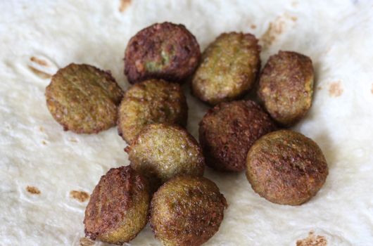 close up of baked Falafel on a wrap in kitchen