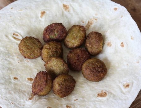 close up of baked Falafel on a wrap in kitchen