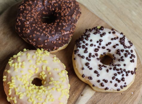 close up of different flavors of donuts