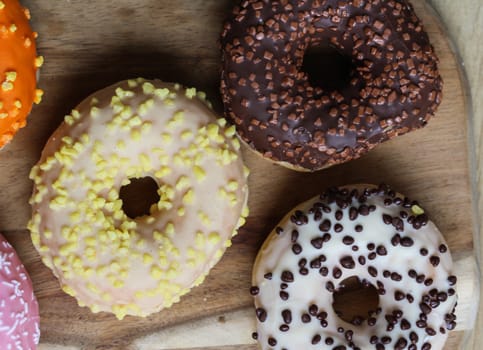 close up of different flavors of donuts