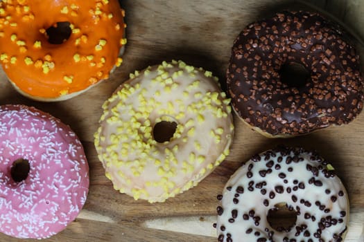 close up of different flavors of donuts