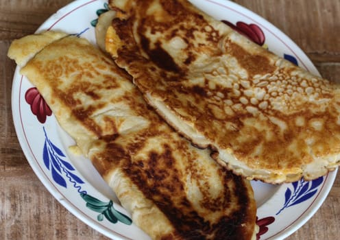 close up of pancake with cheese and bacon