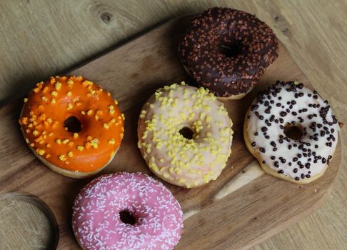 close up of different flavors of donuts