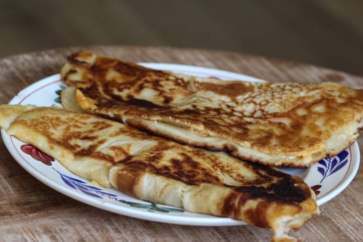 close up of pancake with cheese and bacon