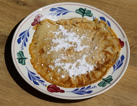 close up of pancake with powdered sugar