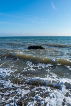 Lonely stone in the sea at the coast