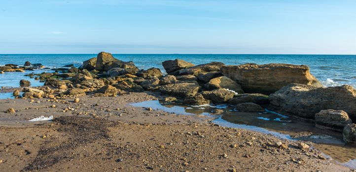 Big stones on the edge of the Black Sea. Autumn day by the sea near the village of Fontanka, Odessa region, Ukraine