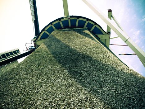 View of a windmill from the bottom up to the wings and sky