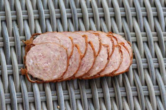 close up of Dutch grilled sausage "grillworst" on wooden table background