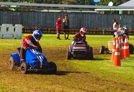 A few drivers participating in a lawnmower race