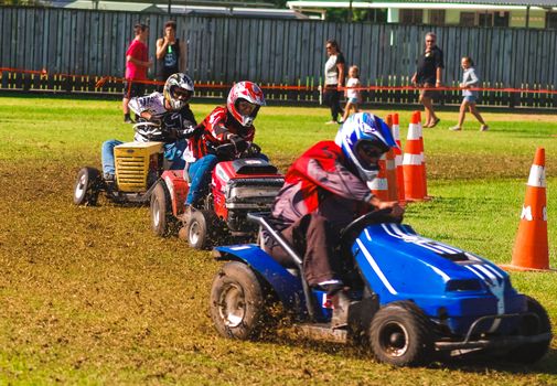 A few drivers participating in a lawnmower race