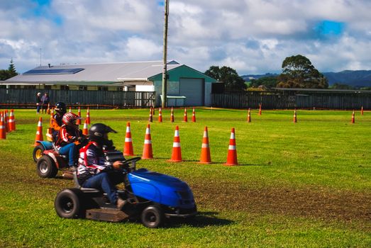 A few drivers participating in a lawnmower race